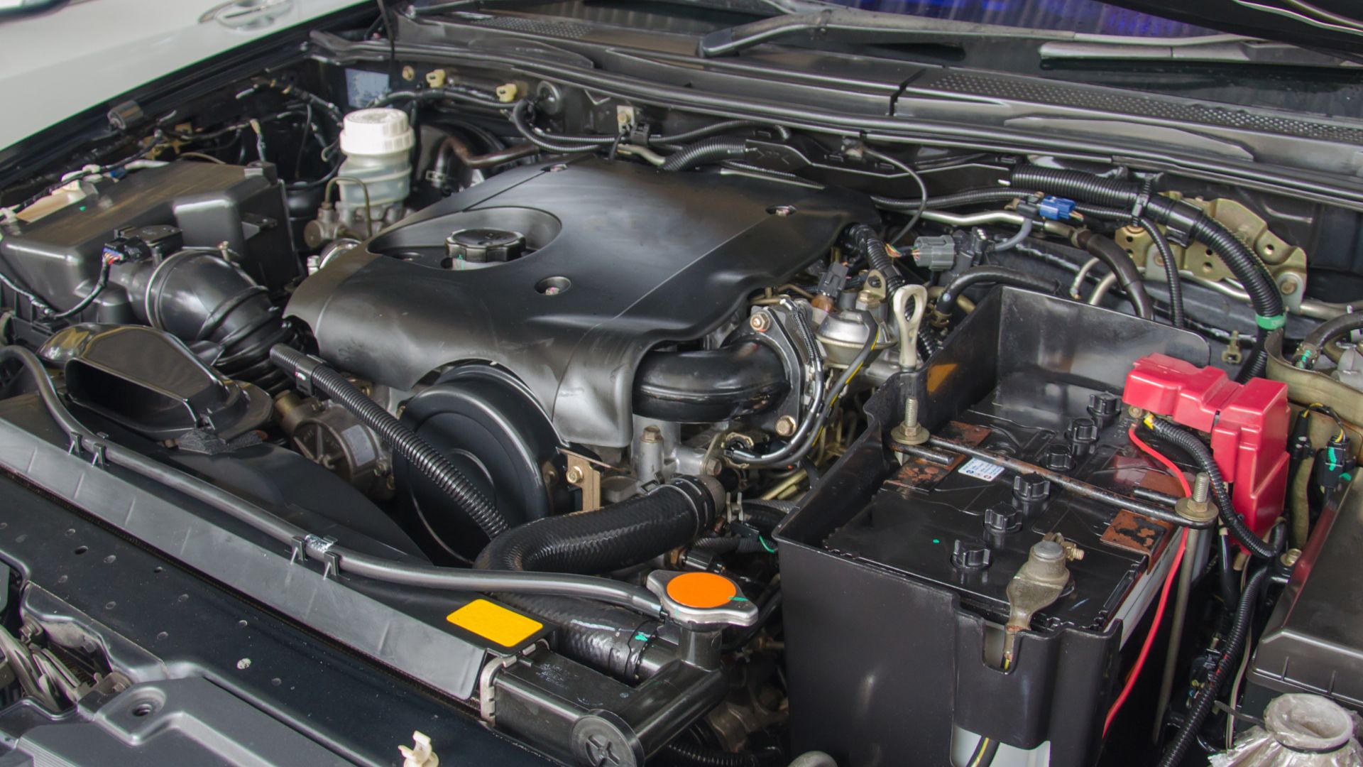 Close-up of a car engine compartment with complex mechanical components